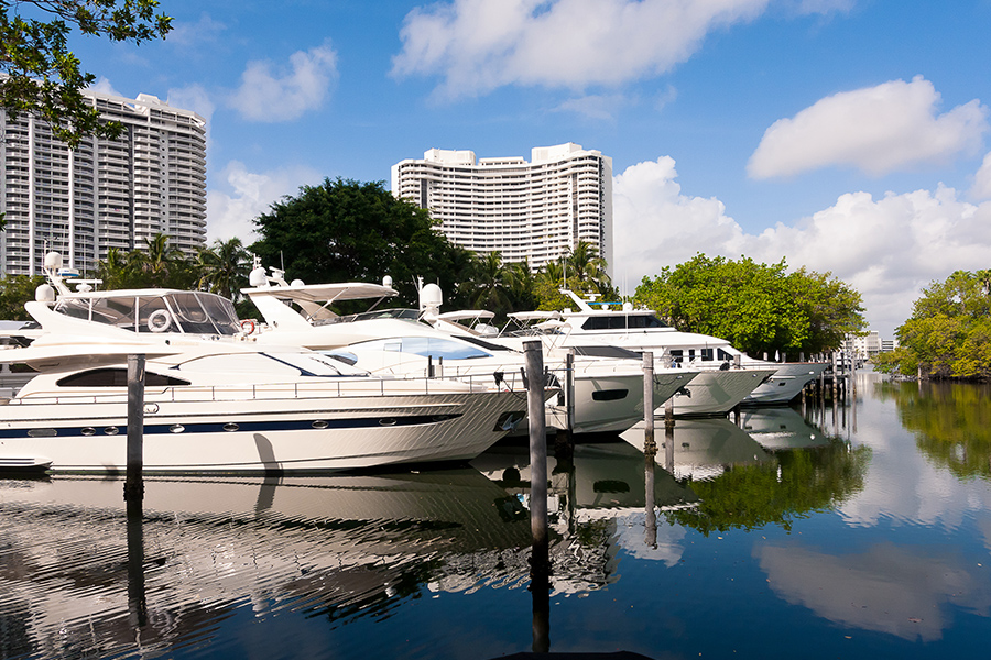 Aventura, FL - Yachts in a Marina in Aventura, Florida on a Birght Sunny Day with Resort Hotel Buildings in the Background